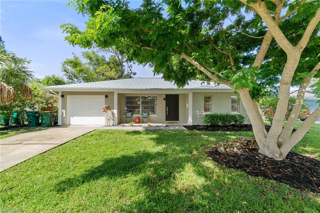 3543 Corana Way Naples, FL 34105 - Photo 1 of 26 a front view of house with yard and green space