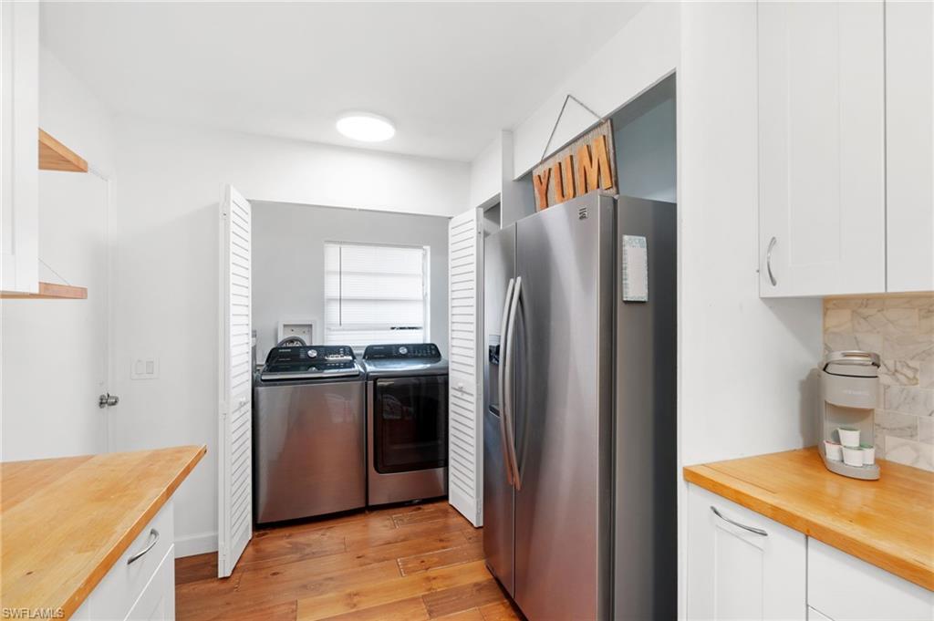 3543 Corana Way Naples, FL 34105 - Photo 11 of 26 a kitchen with stainless steel appliances granite countertop a refrigerator and a sink