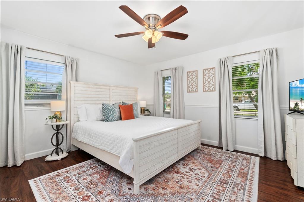 3543 Corana Way Naples, FL 34105 - Photo 12 of 26 a bedroom with a bed and wooden floor