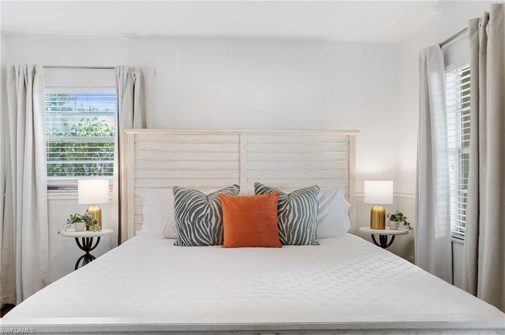 3543 Corana Way Naples, FL 34105 - Photo 13 of 26 a bedroom with a bed and window