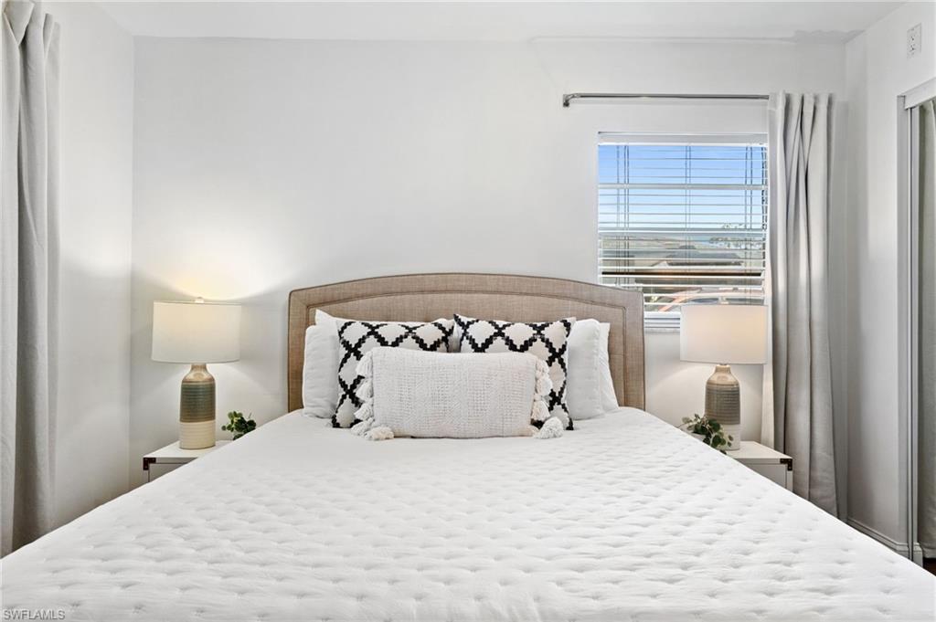 3543 Corana Way Naples, FL 34105 - Photo 19 of 26 a bedroom with a bed and a window