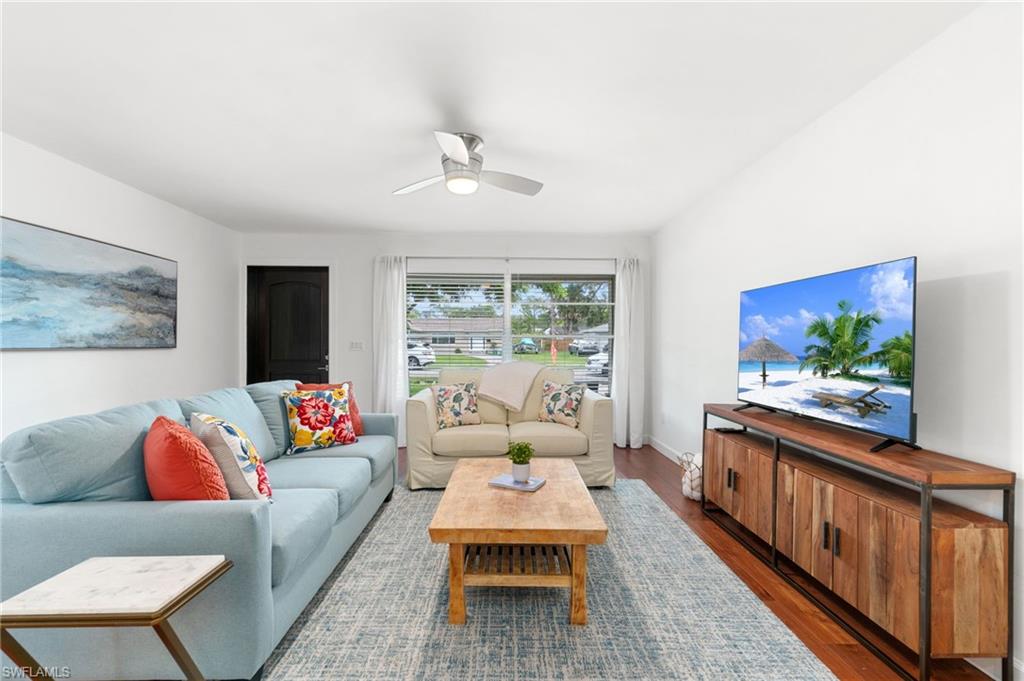 3543 Corana Way Naples, FL 34105 - Photo 2 of 26 a living room with furniture and a flat screen tv