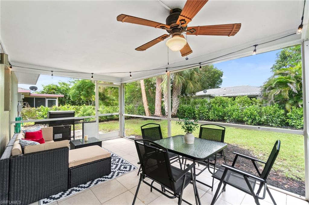3543 Corana Way Naples, FL 34105 - Photo 21 of 26 a view of a dining table and chairs in the patio