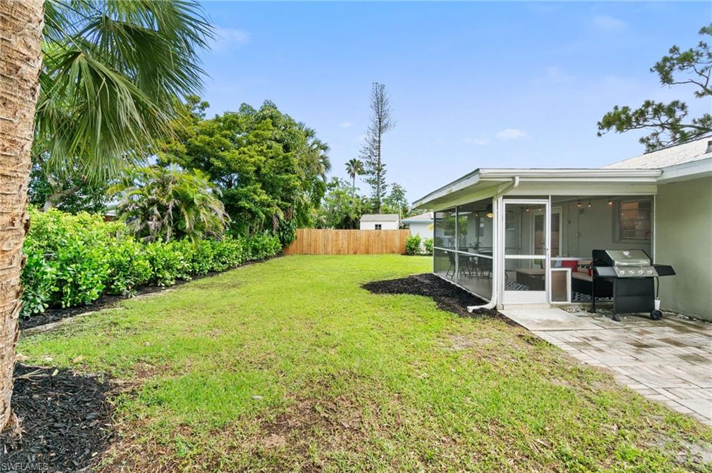 3543 Corana Way Naples, FL 34105 - Photo 24 of 26 a view of a house with backyard porch and sitting area
