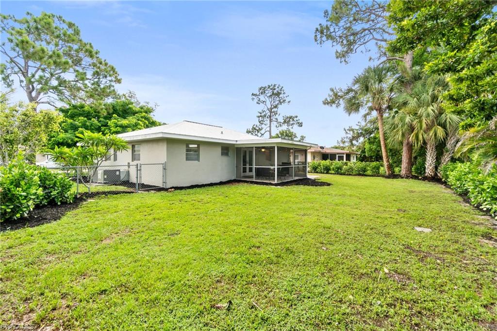 3543 Corana Way Naples, FL 34105 - Photo 25 of 26 a front view of a house with a garden