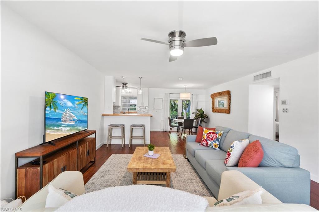 3543 Corana Way Naples, FL 34105 - Photo 3 of 26 a living room with furniture and a flat screen tv