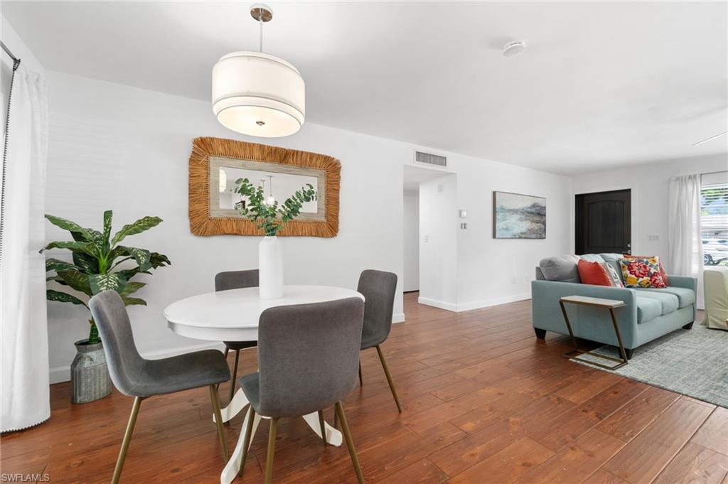 3543 Corana Way Naples, FL 34105 - Photo 6 of 26 a view of a livingroom with dining room and wooden floor