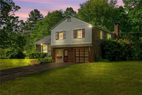 a front view of a house with a yard