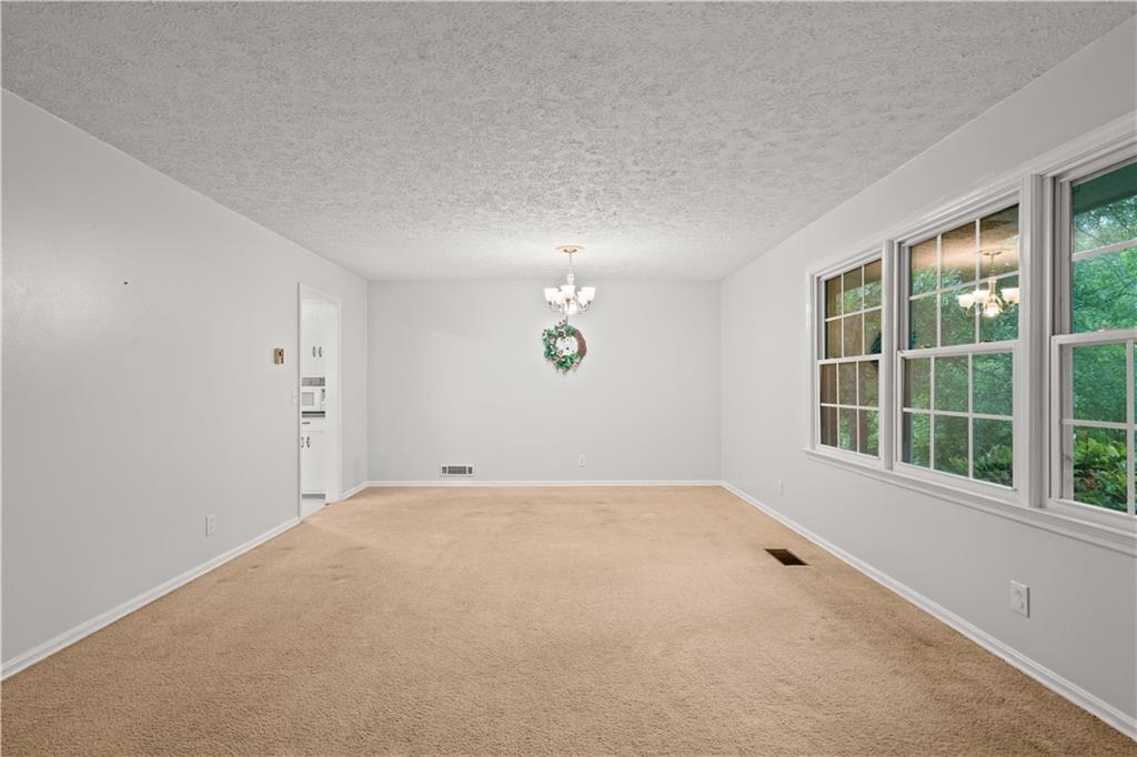 768 Burwell Road Carrollton, GA 30117 - Photo 13 of 42 wooden floor in an empty room with a window