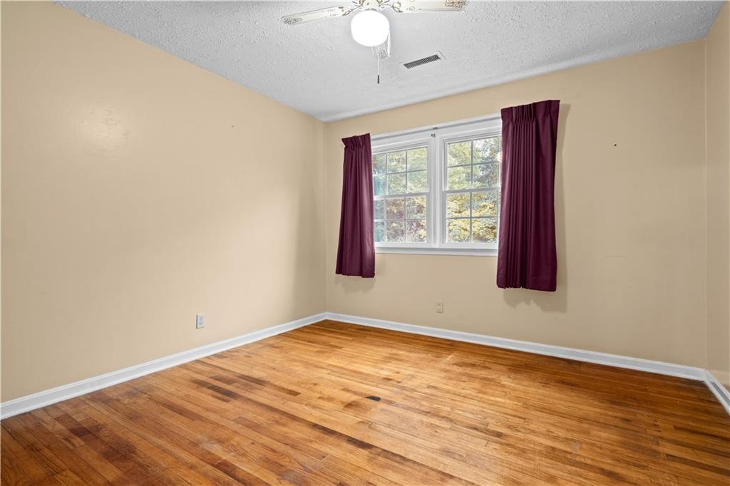 768 Burwell Road Carrollton, GA 30117 - Photo 16 of 42 a view of an empty room with wooden floor and a window