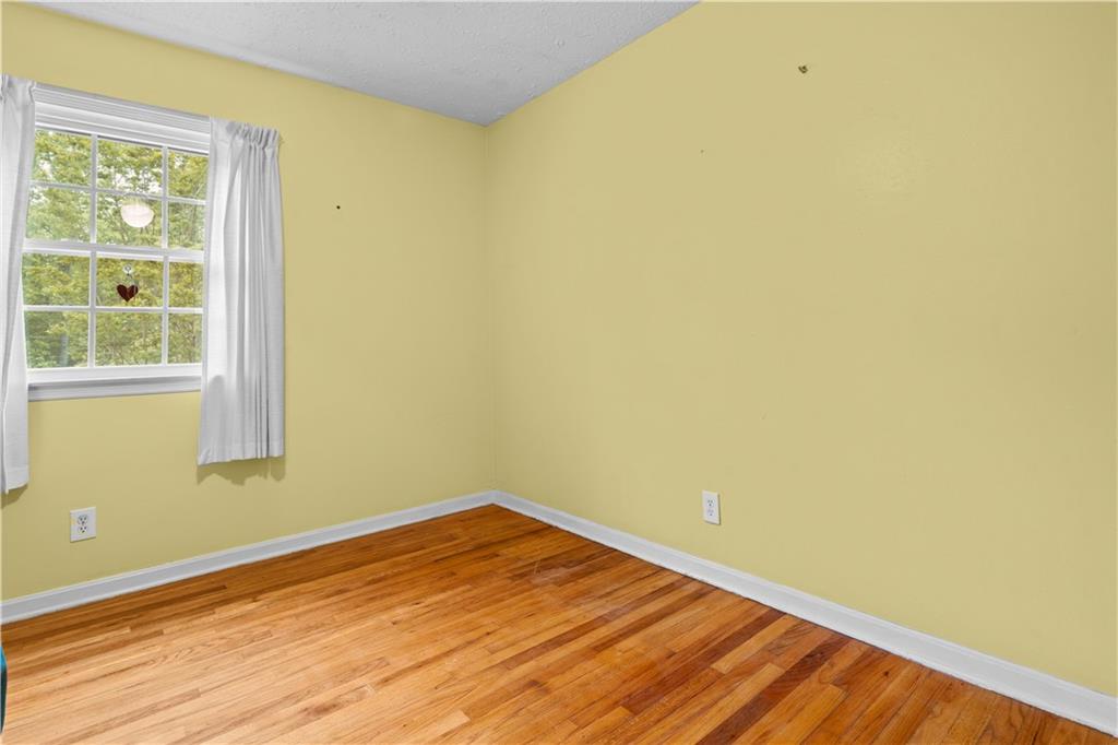 768 Burwell Road Carrollton, GA 30117 - Photo 17 of 42 a view of empty room with wooden floor and fan