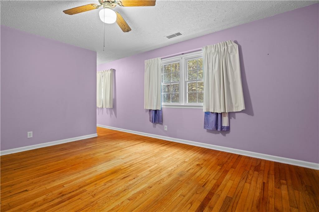 768 Burwell Road Carrollton, GA 30117 - Photo 20 of 42 a view of an empty room with a window and hardwood floor