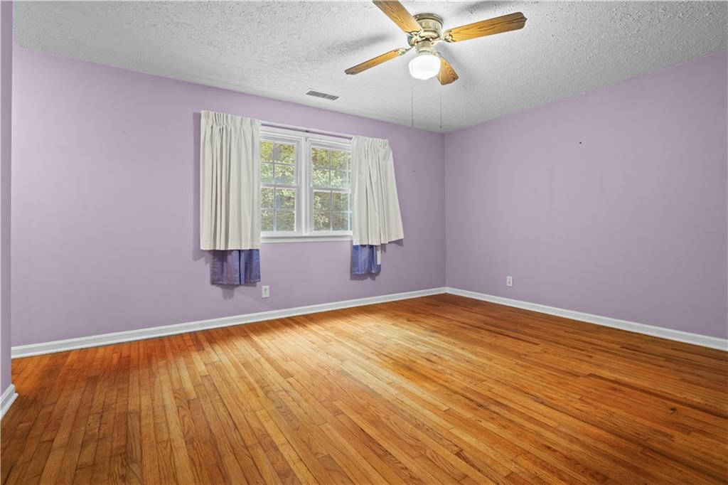 768 Burwell Road Carrollton, GA 30117 - Photo 21 of 42 a view of an empty room with wooden floor and a window