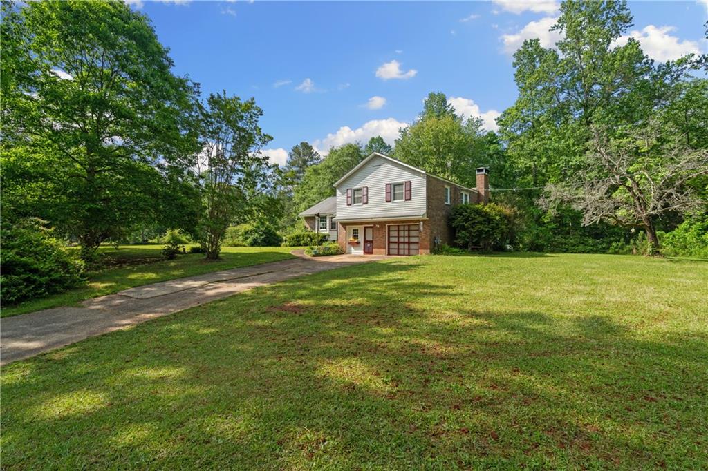 768 Burwell Road Carrollton, GA 30117 - Photo 5 of 42 a front view of a house with a yard
