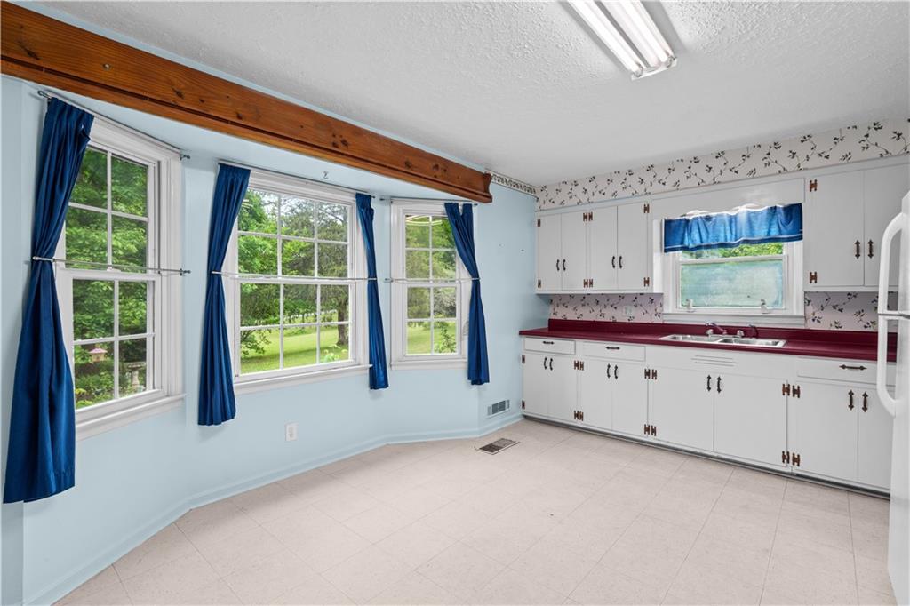 768 Burwell Road Carrollton, GA 30117 - Photo 8 of 42 a kitchen with cabinets a sink and a window