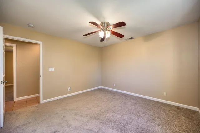 an empty room with closet and windows