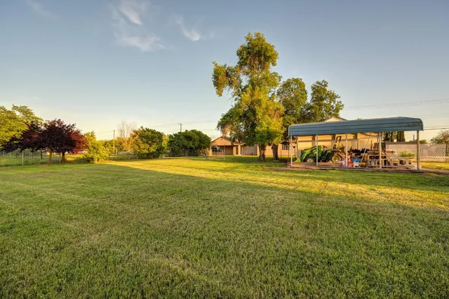 a view of a small house in the green field