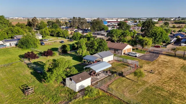 an aerial view of a house with garden space and street view