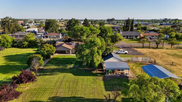 an aerial view of a house with a yard