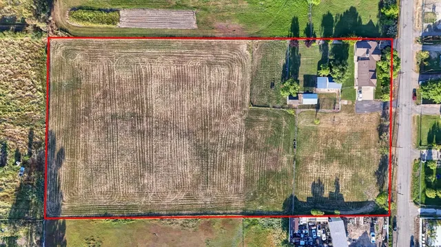 an aerial view of a tennis ground and a cars park