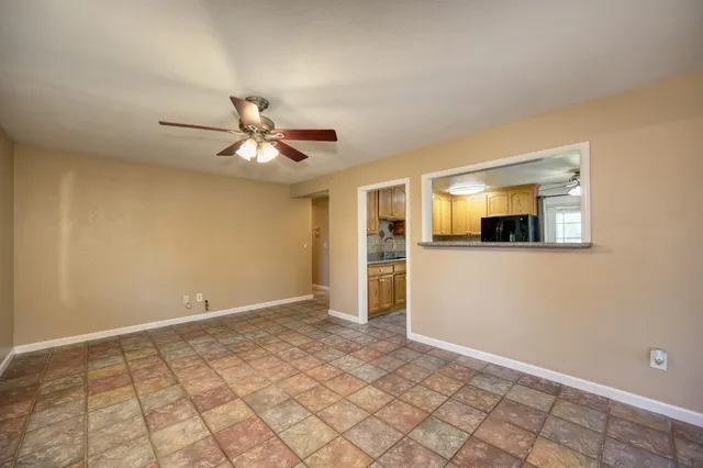 a view of a livingroom with a ceiling fan and wooden floor