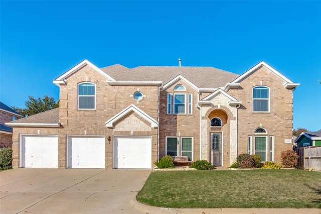 a view of a white house with a yard and plants