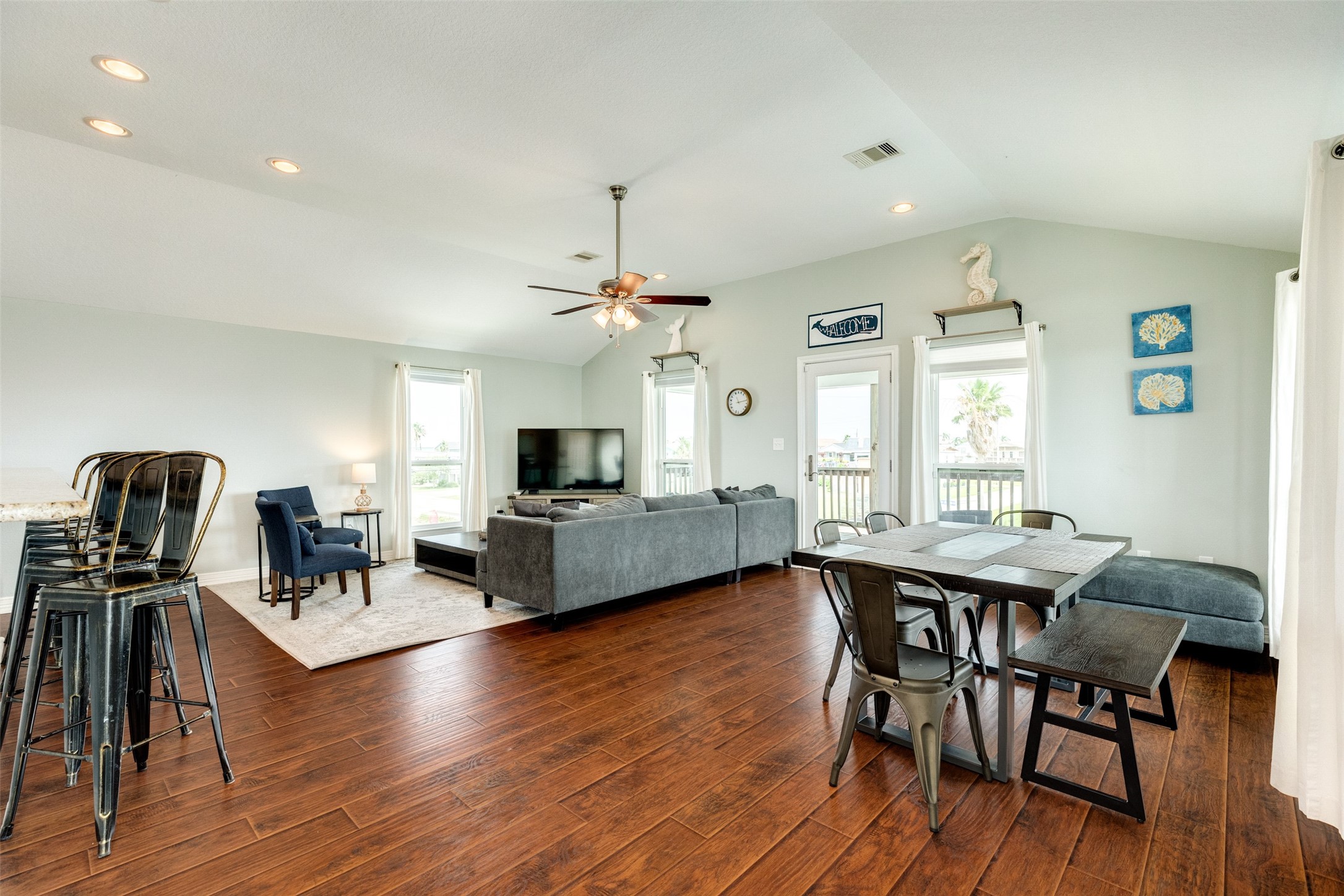 16547 Jolly Roger Road Jamaica Beach, TX 77554 - Photo 16 of 27 a view of a dining room with furniture and wooden floor