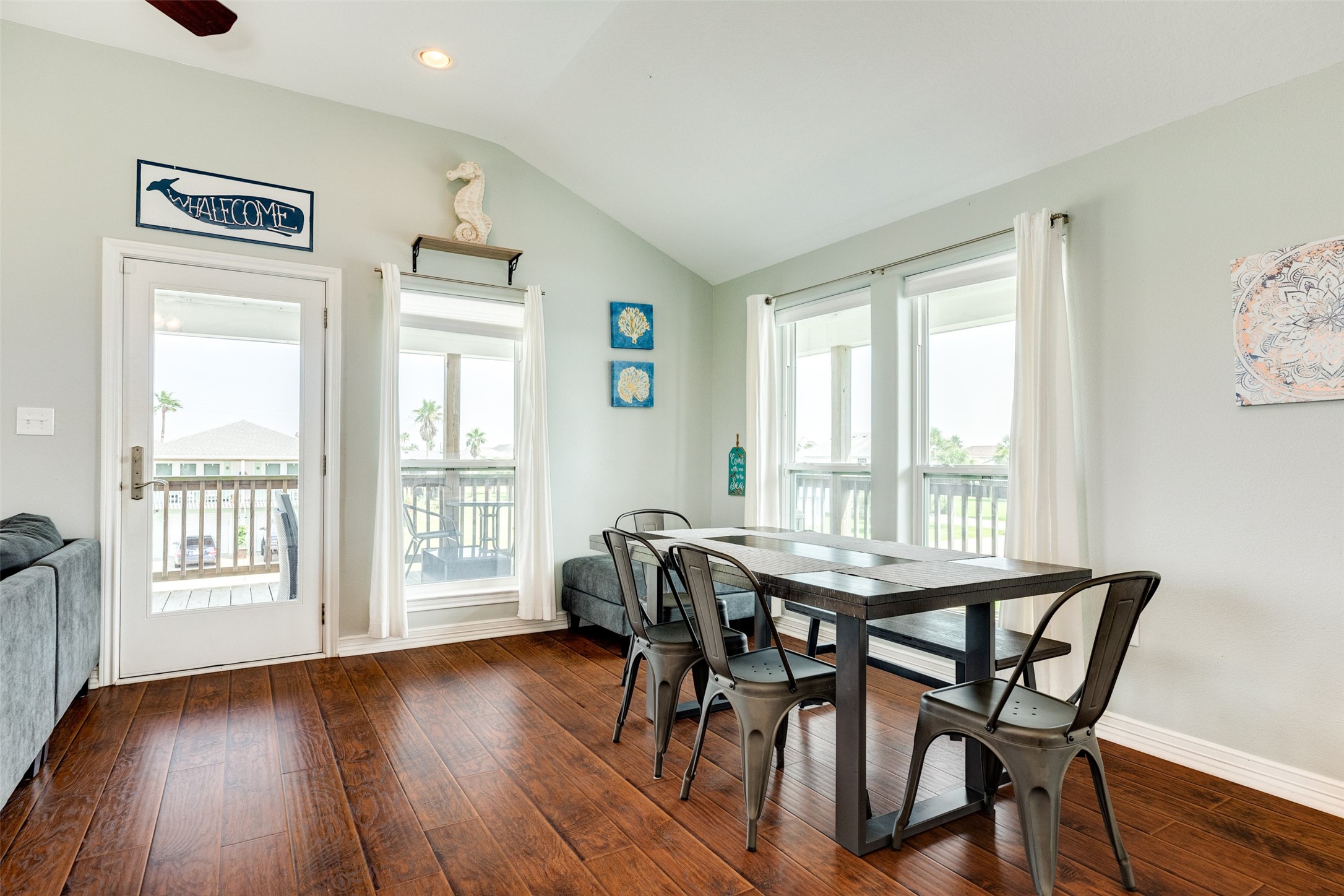 16547 Jolly Roger Road Jamaica Beach, TX 77554 - Photo 19 of 27 a view of a dining room with furniture and wooden floor