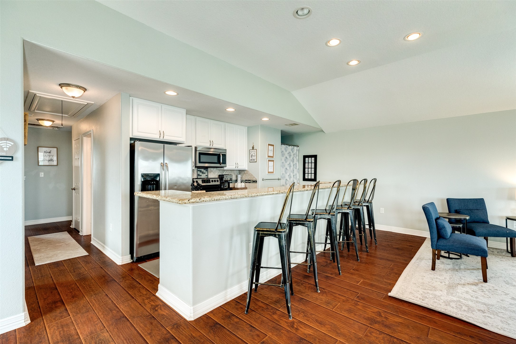 16547 Jolly Roger Road Jamaica Beach, TX 77554 - Photo 20 of 27 a view of kitchen with refrigerator and wooden floor