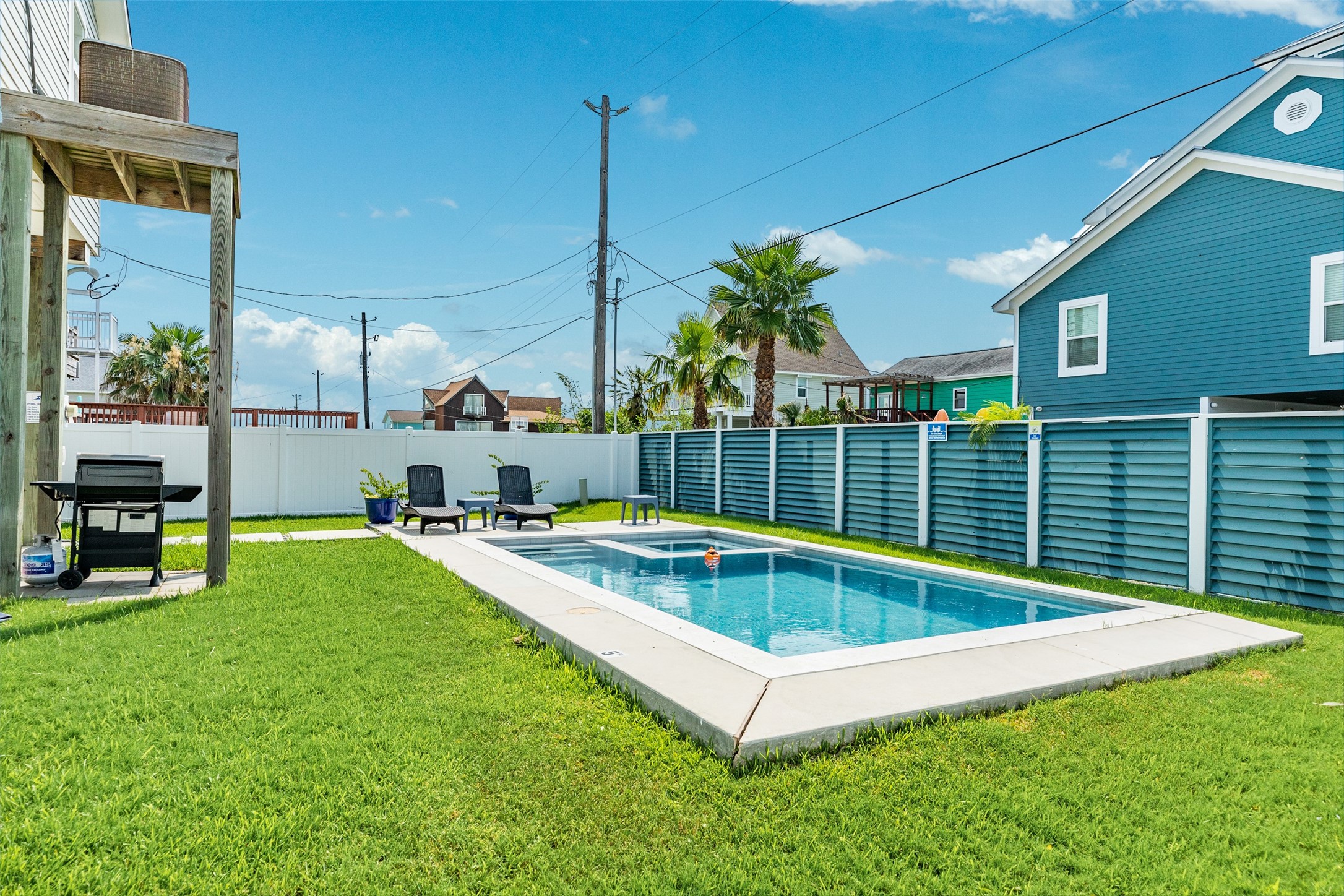 16547 Jolly Roger Road Jamaica Beach, TX 77554 - Photo 5 of 27 a view of a backyard with a patio and swimming pool
