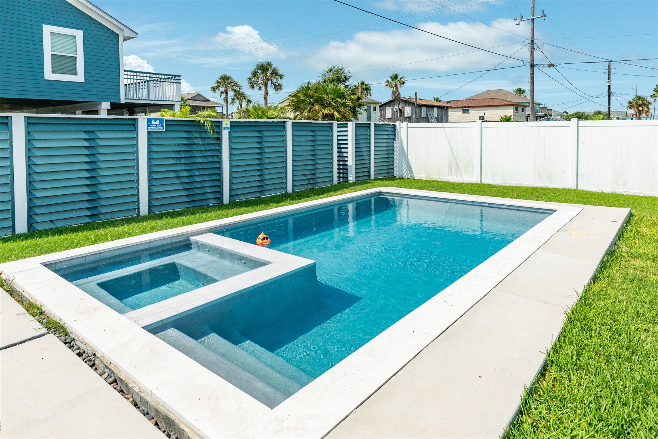 16547 Jolly Roger Road Jamaica Beach, TX 77554 - Photo 6 of 27 a view of a swimming pool with a chair