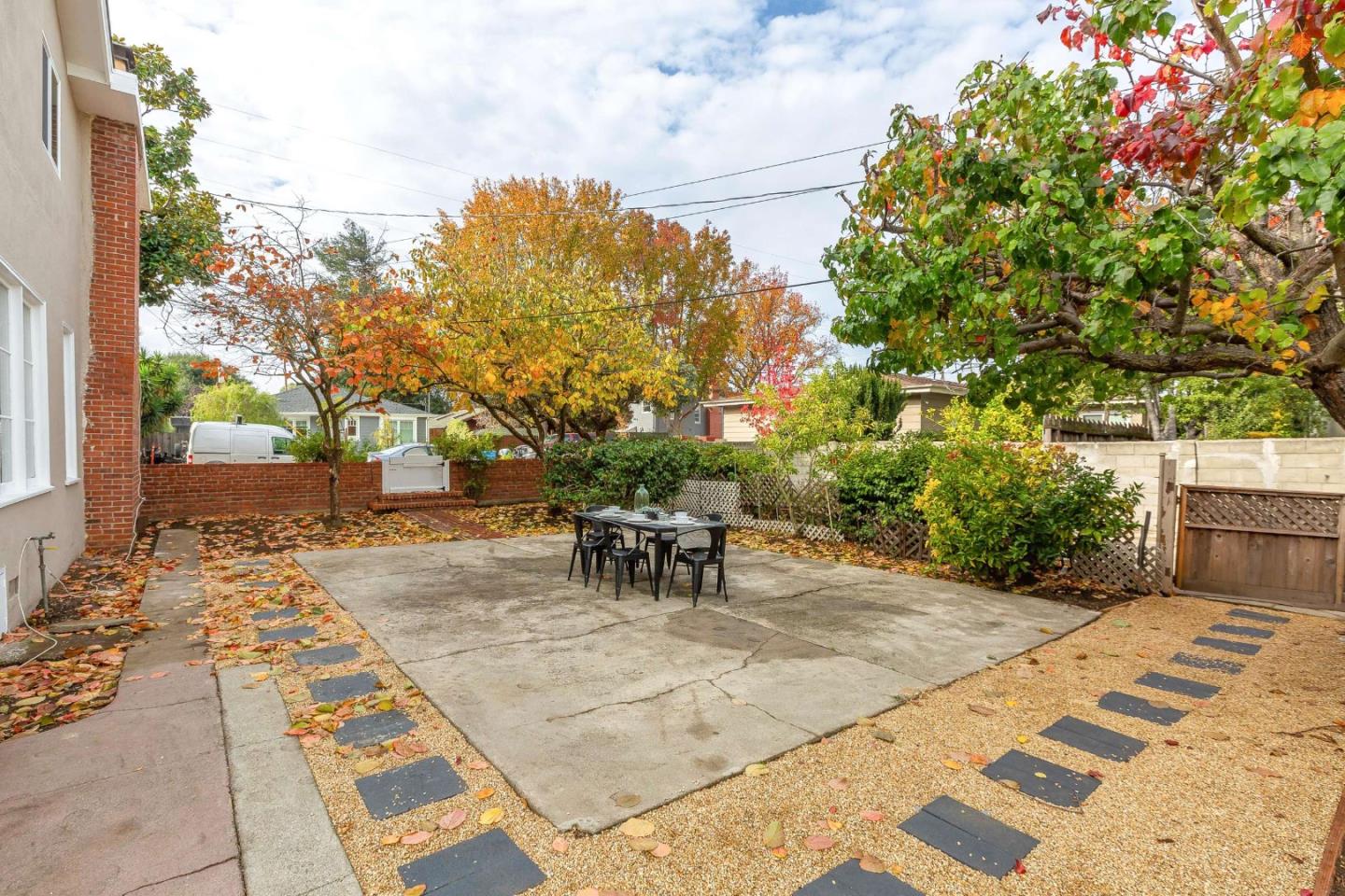 230 Victoria Road Burlingame, CA 94010 - Photo 42 of 69 a view of a patio with a table and chairs and potted plants