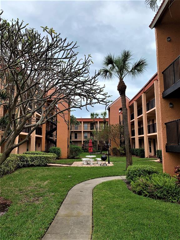 8921 Blind Pass Road, Unit 149 St. Pete Beach, FL 33706 - Photo 1 of 1 a front view of a house with a yard