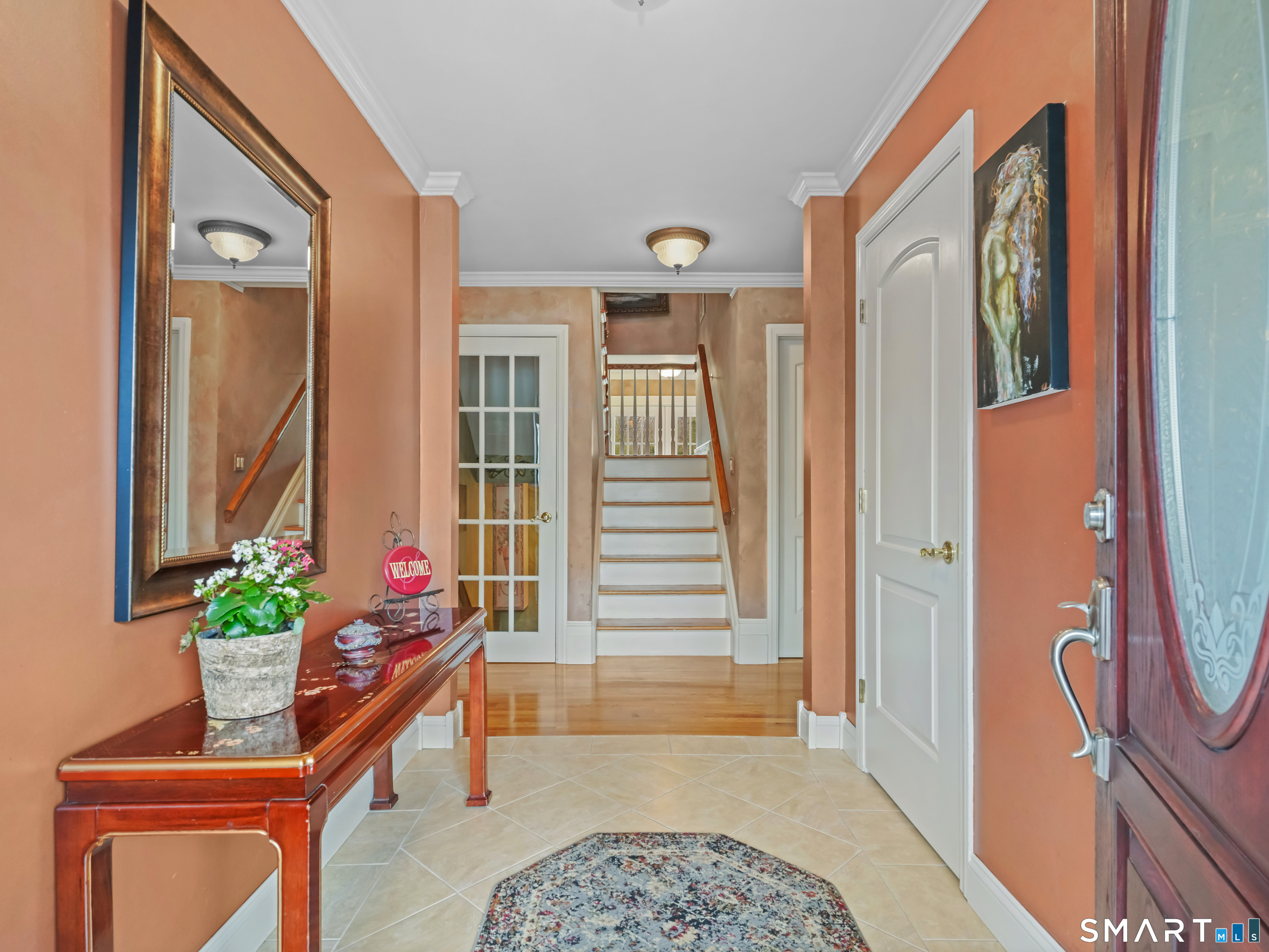 82 Ramapoo Road Ridgefield, CT 06877 - Photo 8 of 40 a front view of a house with wooden floor and a potted plant