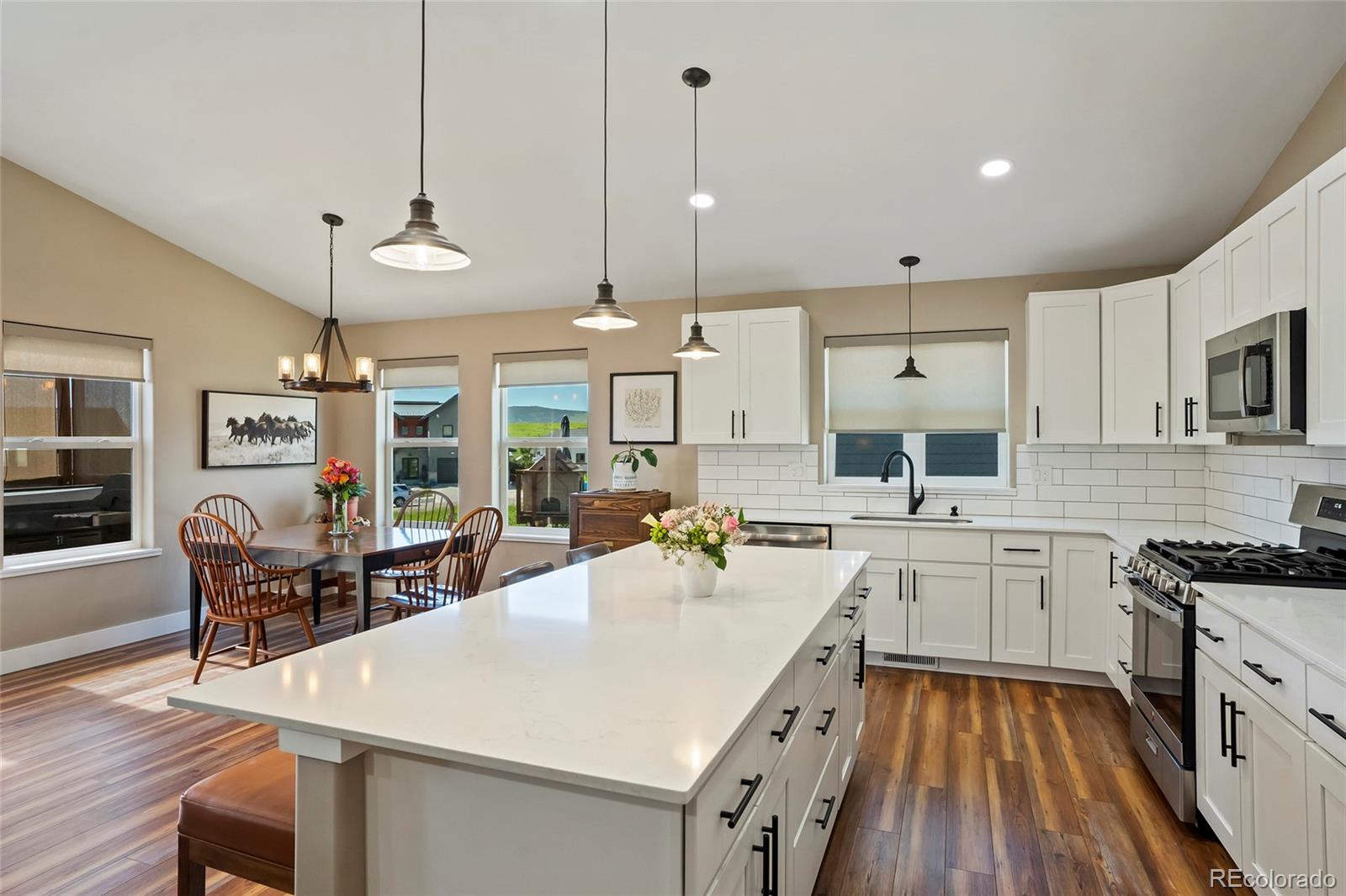 365 Lake View Road Hayden, CO 81639 - Photo 3 of 24 a kitchen with a stove a sink a dining table and chairs