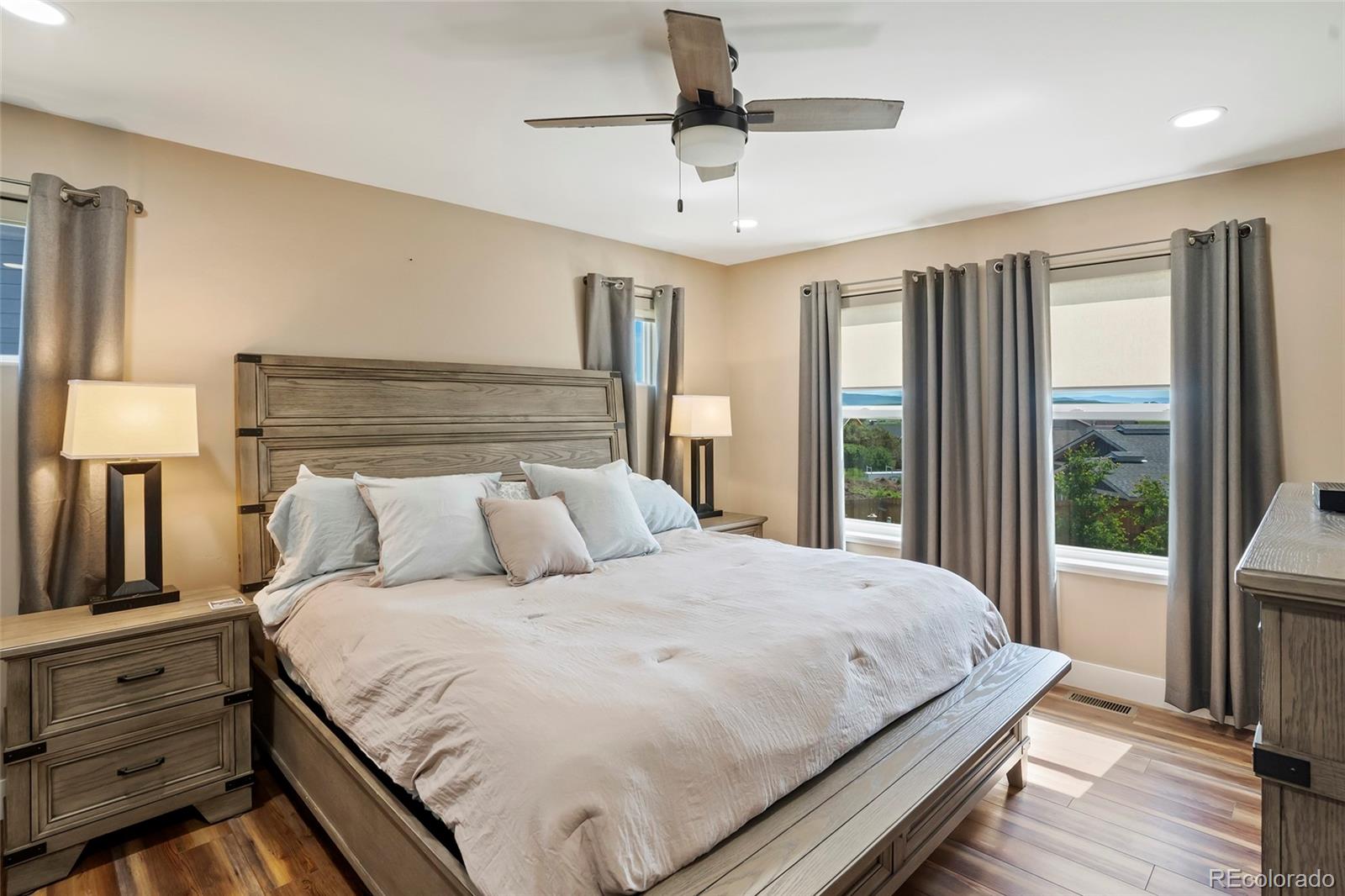 365 Lake View Road Hayden, CO 81639 - Photo 9 of 24 a bedroom with a large bed and a chandelier fan