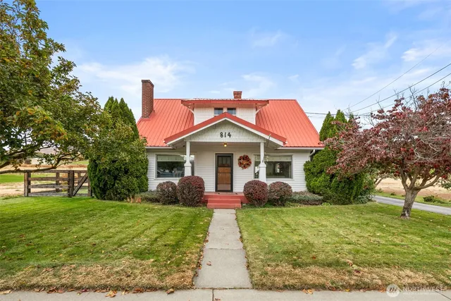 a front view of house with yard and green space