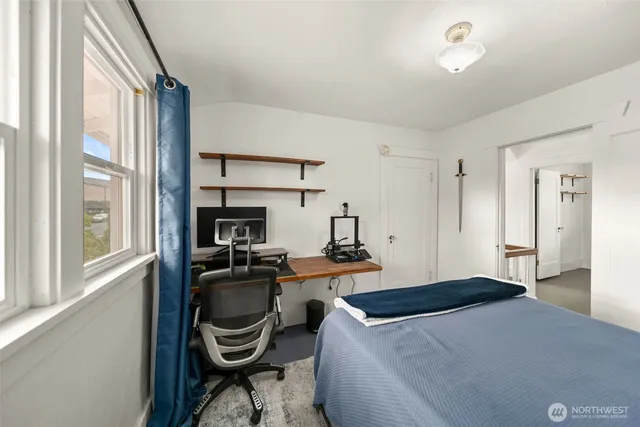 a bedroom with a bed and a chair