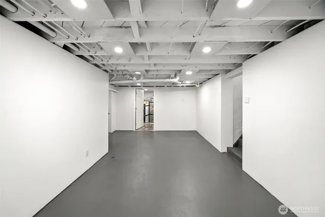 a view of a hall with a ceiling fan and windows