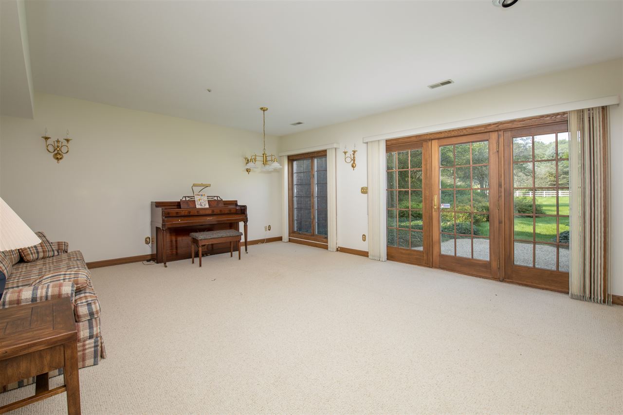 1734 Riverside Road Belvidere, IL 61008 - Photo 26 of 40 a view of an empty room with furniture and a window