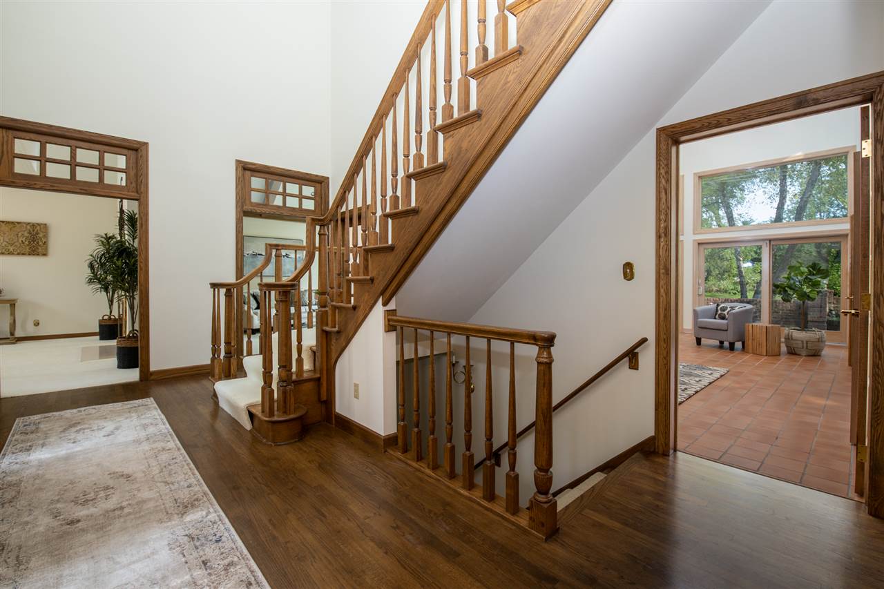 1734 Riverside Road Belvidere, IL 61008 - Photo 3 of 40 a view of staircase with wooden floor and a large window