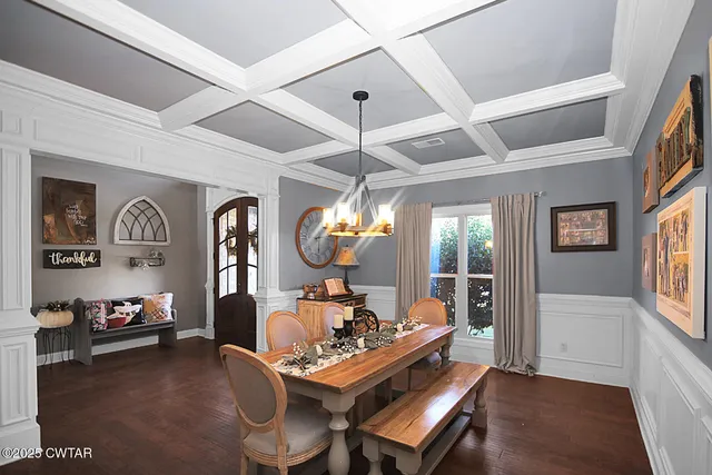 a living room with furniture a large window and a chandelier