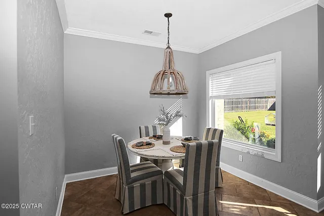 a dining room with furniture and window