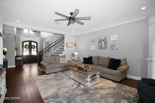 a living room with furniture and a wooden floor