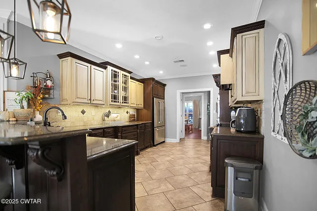 a kitchen with stainless steel appliances granite countertop a sink stove and cabinets