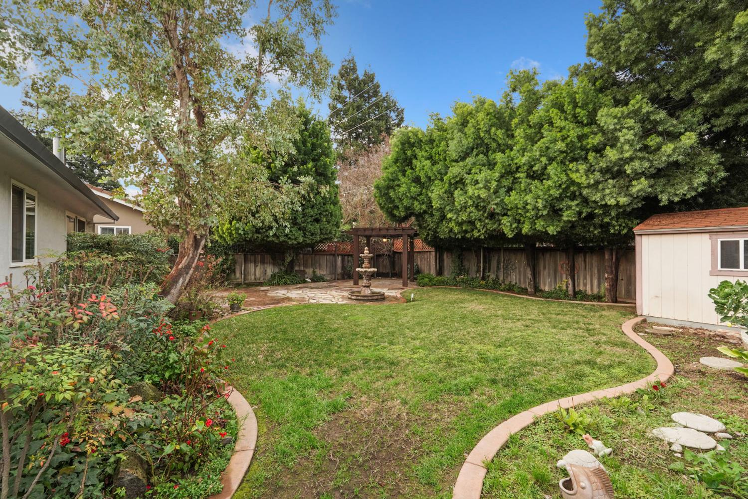 1007 Cardinal Street Lodi, CA 95240 - Photo 26 of 31 a backyard with a table and chairs and potted plants