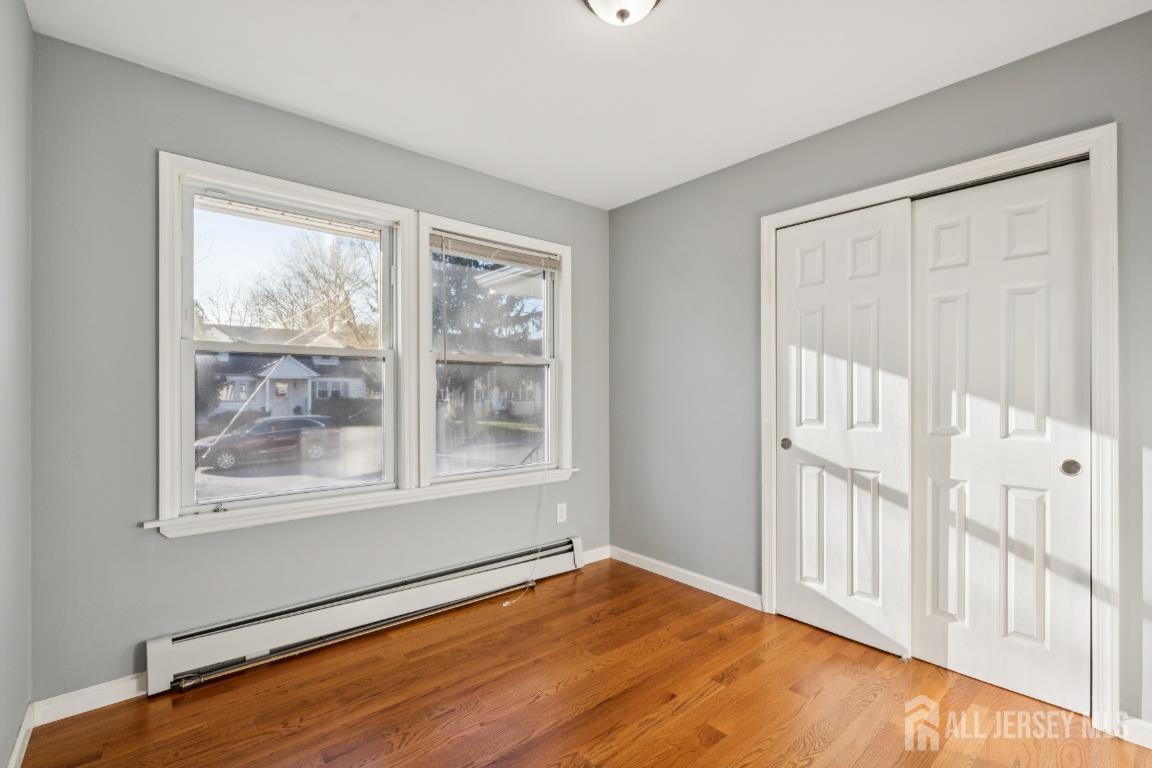 25 Reed Street Edison, NJ 08817 - Photo 11 of 23 a view of an empty room with wooden floor and a window