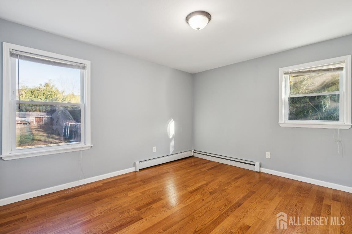25 Reed Street Edison, NJ 08817 - Photo 14 of 23 a view of empty room with wooden floor and fan