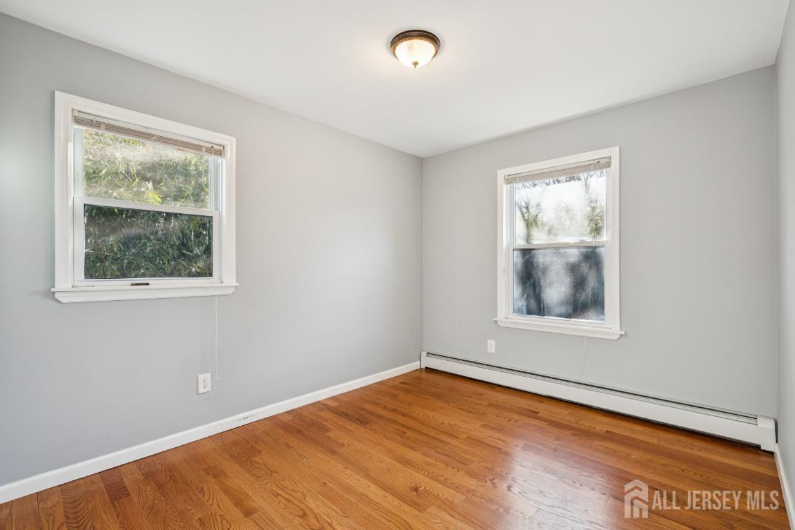 25 Reed Street Edison, NJ 08817 - Photo 16 of 23 a view of an empty room with wooden floor and a window