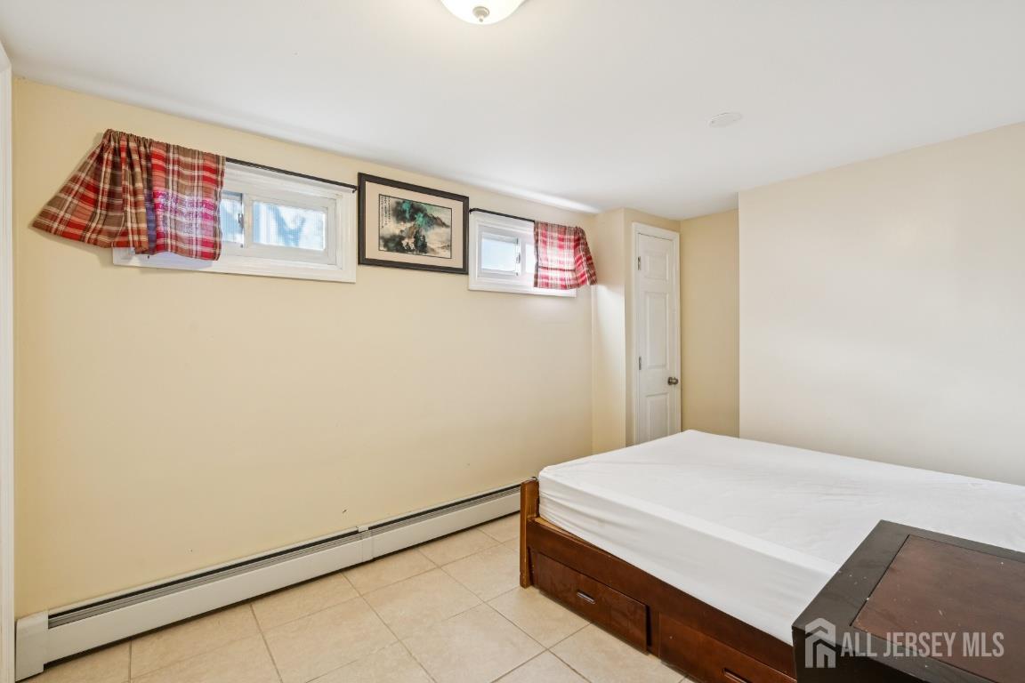 25 Reed Street Edison, NJ 08817 - Photo 18 of 23 a bedroom with a bed and a refrigerator